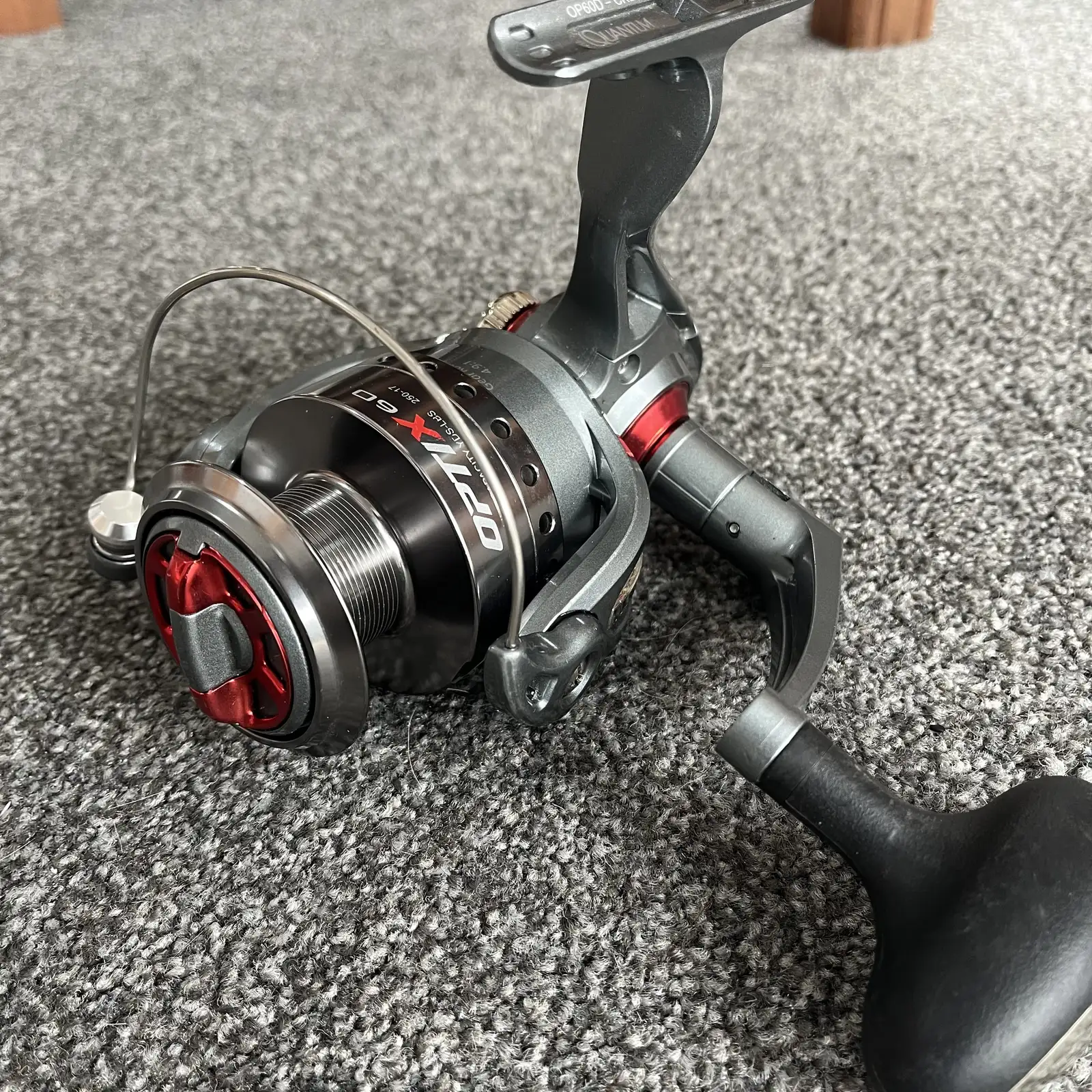 Used Quantum Optix 60 spinning reel, grey and red, three-quarter view