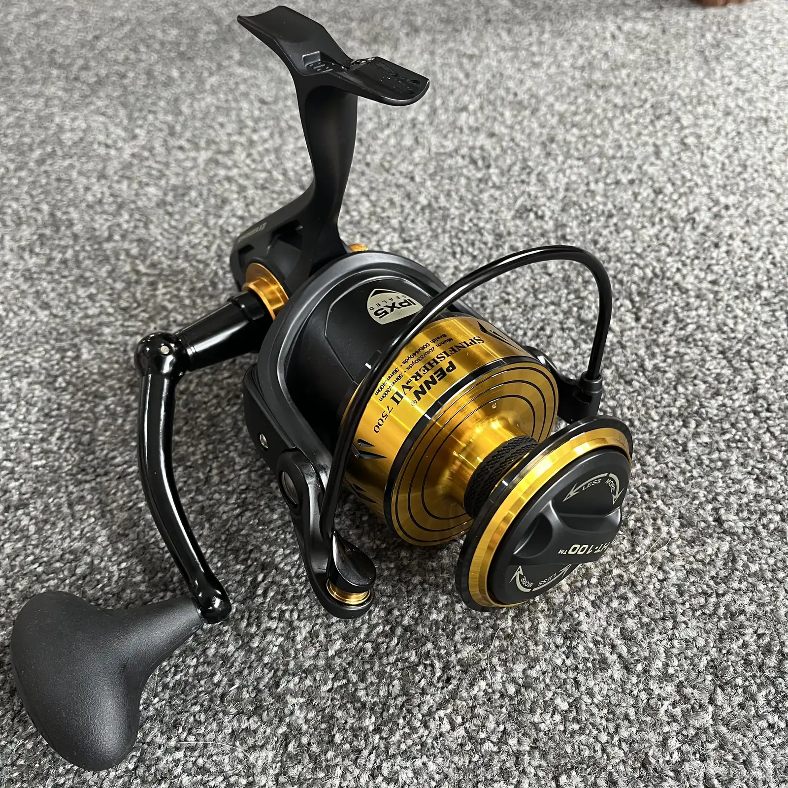 Penn Spinfisher VII 7500 spinning reel, black and gold, three-quarter view